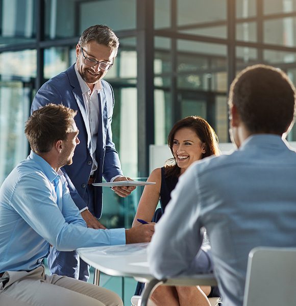 Smiling colleagues having a meeting in office.